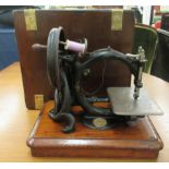 An early 20thC Willcox & Gibbs sewing machine, in a military design, brass band mahogany case  13"h