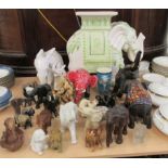 Elephant themed collectables: to include a china garden seat  19"h; and other ornaments  mixed sizes