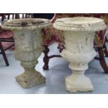 A pair of composition stone pedestal urns, on a square plinth  20"h  15"dia