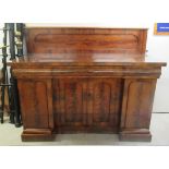 A mid Victorian flame mahogany chiffonier with a panelled upstand, over three frieze drawers and