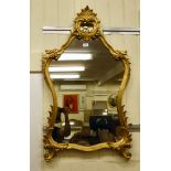 A Victorian style pier glass, the shaped plate set in a foliate scrolled gilt framed  47"h  24"w