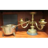 An early 20thC bronze saucepan, on pegged feet; and a later cast brass four branch table centrepiece