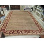 A Caucasian carpet, decorated with a foliate patterned boarder and lined pattern centre, on a