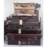 Mainly late 19thC early stitched brown hide suitcases  largest 11"h  30"w