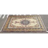 A Persian rug, decorated with a central medallion, bordered by foliage and urn motifs, on a multi-