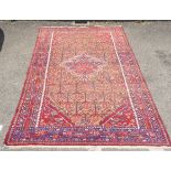 A Persian rug, decorated with repeating stylised designs, on a multi-coloured ground  59" x 102"