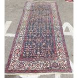 A Persian runner, decorated with repeating stylised decoration, on a multi-coloured ground  41" x