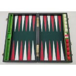 A stitched hide cased backgammon set with thirty counters and five dice
