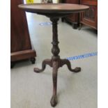 A 1930s Georgian design mahogany tip-top occasional table with a carved column, splayed tripod base,