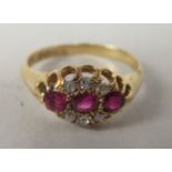 An 18ct gold ruby and diamond cluster ring