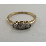 An 18ct gold three stone diamond ring