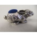 A silver coloured metal novelty pin cushion, fashioned as a seated hare  stamped 925