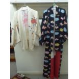 A Japanese kimono, lined and printed in colours with a flowerhead design, on a black ground; and