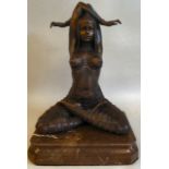 A modern Art Deco style patinated bronzed metal figure, a female, meditating, on a marble plinth