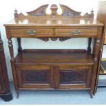 A late Victorian mahogany carved buffet with two inline drawers, over an open shelf and two door