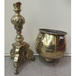 An early 20thC cast brass jardinière with opposing mask ring handles, on a floral decorated column