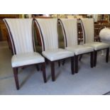 A set of four modern dining chairs, having cream coloured, stitched hide fan design backs raised