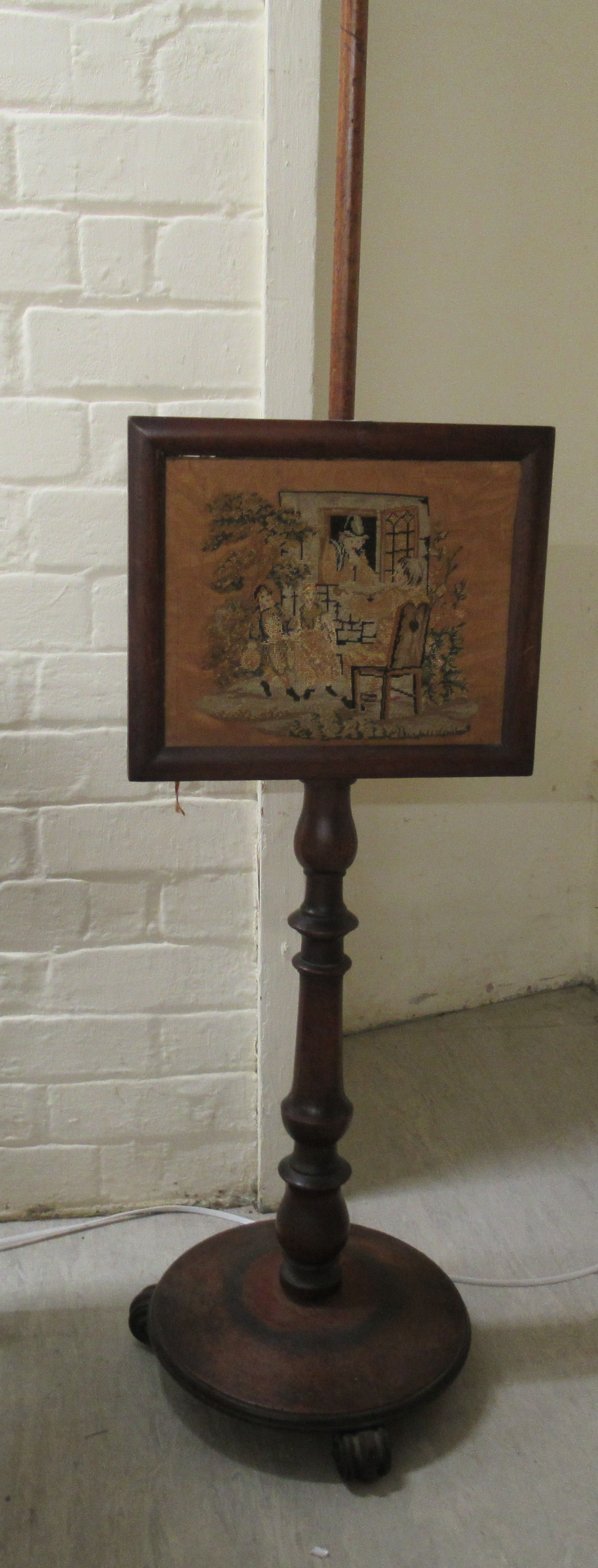 An early Victorian mahogany pole screen with a height adjustable tapestry panel  55"h