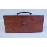 A late Victorian/Edwardian tooled mid brown hide covered jewellery box, the hinged lid secured by