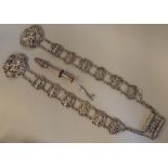White coloured metal items: to include an ornately cast tablet and chain link belt
