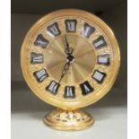 A Jaeger gilt metal barrel clock; the 8 day movement faced by a Roman dial with an alarm  4"h