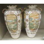 A pair of 20thC Japanese twin handed porcelain baluster shaped vases, decorated with pictorial