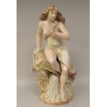 An early 20thC Scottish pastel coloured, glazed and gilded porcelain figure, a maiden with long