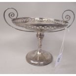 An Edwardian silver comport with a uniformly pierced border and opposing, swept, loped wire handles,