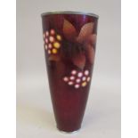 A 20thC oxblood coloured enamel tall beaker vase, decorated with stylised berries and a star leaf