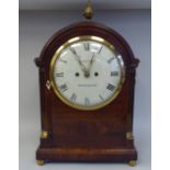 An early 19thC round arch, mahogany cased bracket timepiece with lacquered brass mounts, on ball