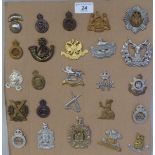 Twenty-five military regimental cap badges and other insignia, some copies: to include The King's