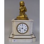 A late 19thC French white marble cased mantel clock, surmounted by a cast gilt metal kneeling