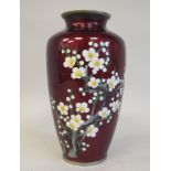 A 20thC oxblood coloured enamel vase of baluster form, decorated with blossoming branches  7.5"h