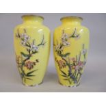 A pair of 20thC yellow enamel baluster shaped vase, each decorated in colours with a bird amid