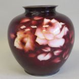 A 20thC oxblood coloured enamel vase of bulbous form, decorated with roses  7.5"h