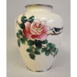 A 20thC cream coloured enamel vase of squat, baluster form, decorated with a hedgerow bird and rose