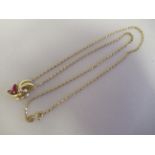 A 14ct gold pendant of floral design, set with rubies and diamonds, on a 9k gold chain