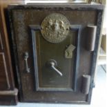 An early 20thC cast iron Milness Patent 'Thief Resistant' safe, the door enclosing two open