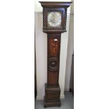 A 1920s oak cased Grandmother clock; the 8 day movement faced by a silvered Roman dial  69"h