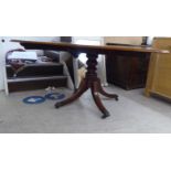 A Regency ebony inlaid crossbanded rosewood and mahogany tip-top dining table, the top with curved