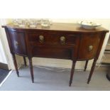 A George III mahogany bow front sideboard with two central drawers, flanked by two curved drawers,