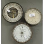 Three early 20thC cast metal drum design barometers, each faced by enamelled dials  6" - 8"dia