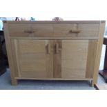 A modern light oak sideboard with two drawers, over two doors, raised on block feet  35"h  48"w