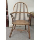 A child's early 20thC beech and oak framed hoop and spindled back Windsor chair, the solid seat