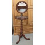 A late Victorian mahogany shaving stand with a height adjustable mirror, raised on a tripod base