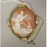 A carved shell cameo brooch, depicting a woman resting on an anchor, mounted in a yellow metal frame