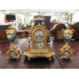 An early 20thC Continental gilt metal and porcelain three piece clock garniture; the movement