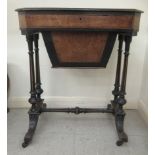 A late Victorian walnut sewing table, the top with a deep drawer, raised on ebonised, tapered,