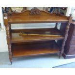 A late Victorian mahogany three tier buffet, raised on turned, block supports, on casters  41"h