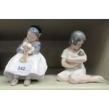 Two Royal Copenhagen porcelain figures, viz. a girl holding a doll  6"h; and a girl knitting  7"h
